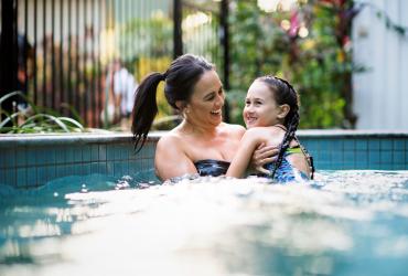 Mother and daughter in pool