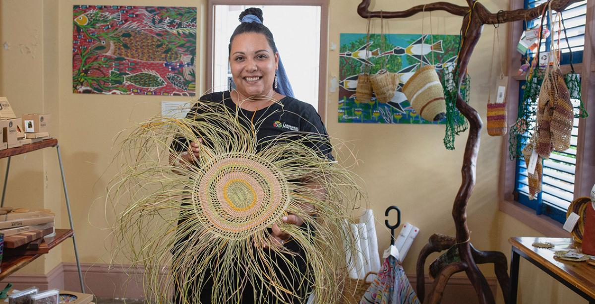 Aboriginal Bush Traders Woman holding Aboriginal weaving