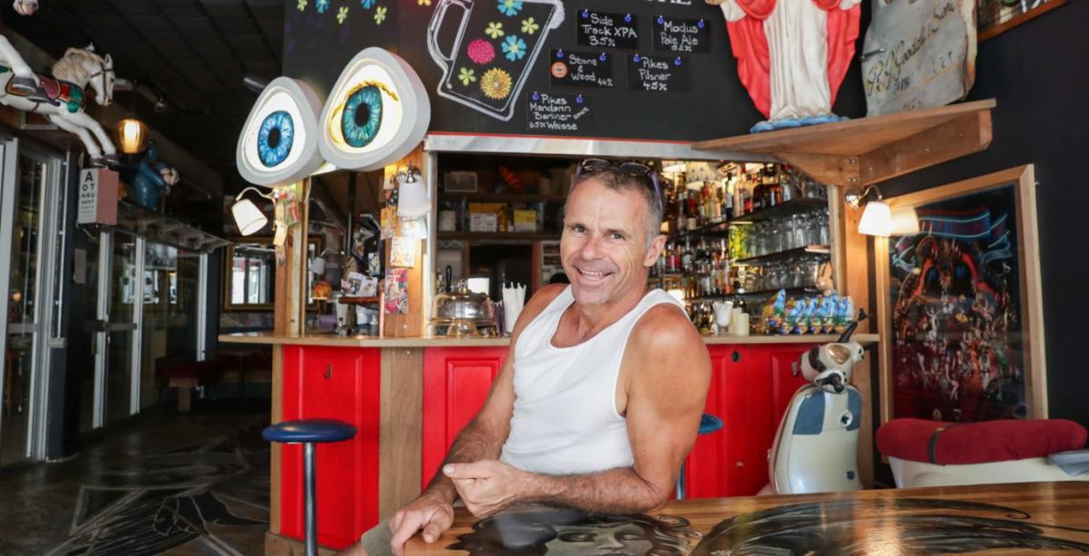 Man sitting in front of bar