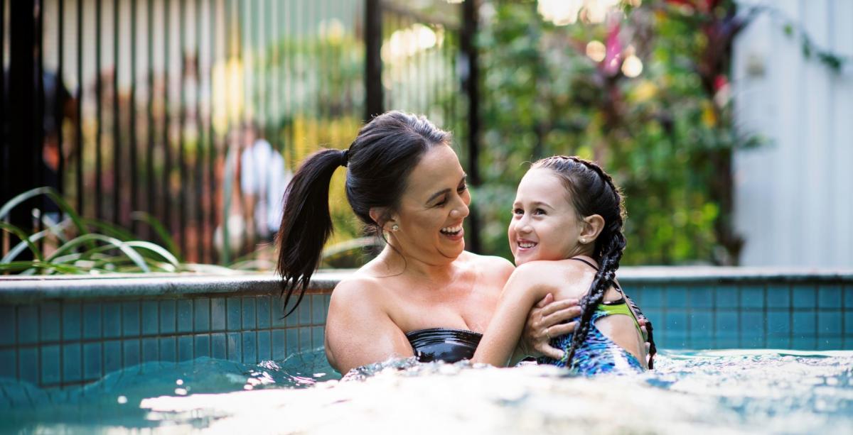 Swimming in pool Mother and daughter in pool