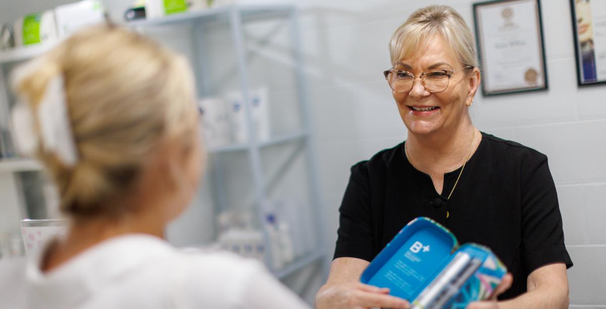 Worker showing products to customer