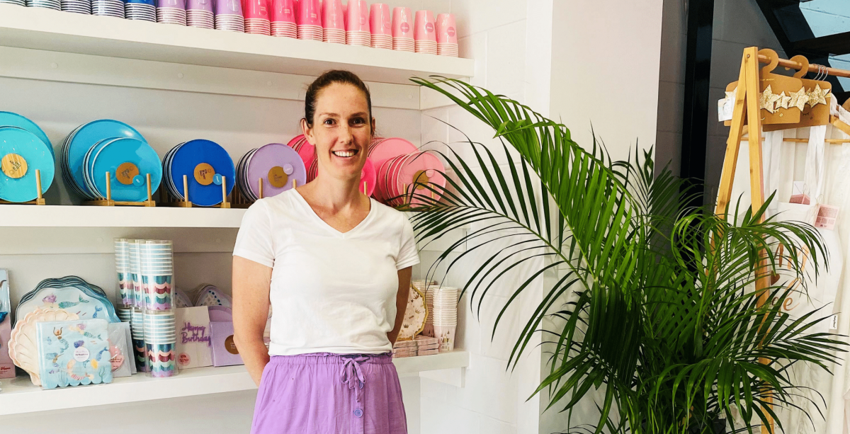 BAM Party and Events Owner Marissa standing in front of party plates and cups